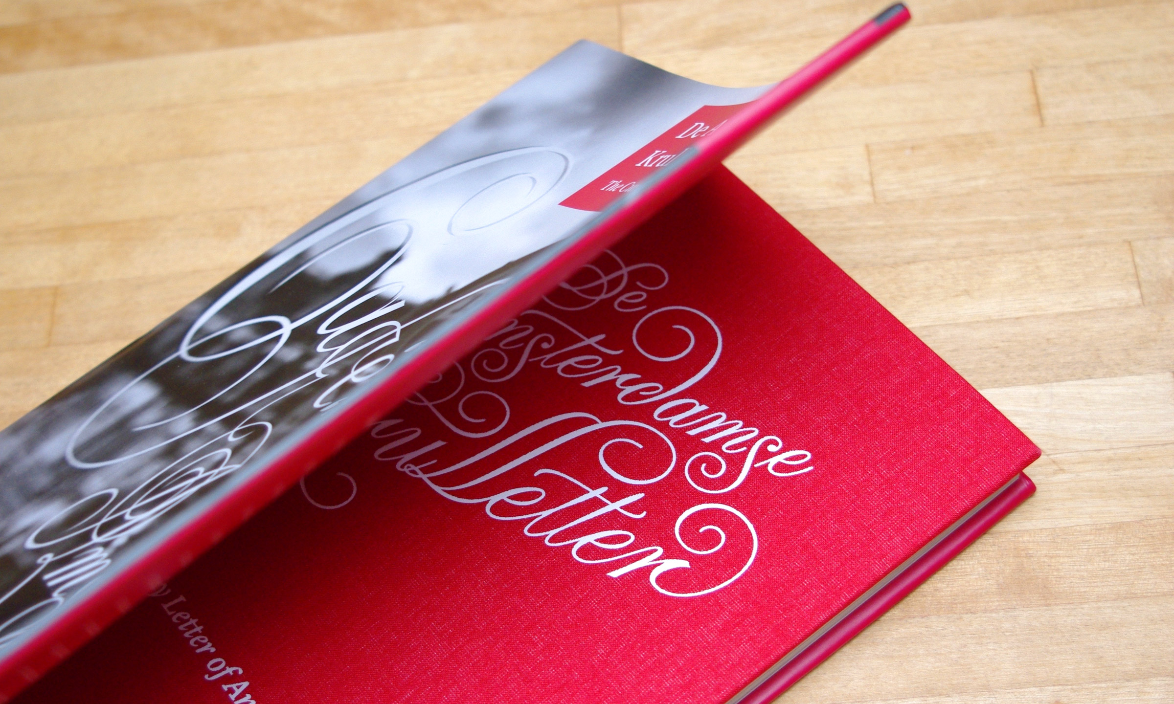 Taking off the dust jacket reveals the beautifully lettered red cloth cover.